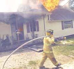 With a dripping hose signaling the end of the water supply, a firefighter heads away as flames consume the home of Rick and Bonnie Spinks earlier this month With a dripping hose signaling the end of the water supply, a firefighter heads away as flames consume the home of Rick and Bonnie Spinks earlier this month