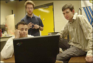 Ryan O'Donnell, left, CEO of start-up company Tek Alert LLC, Keith Lareau, center, the company's chief technology officer, and John Blackburn, the company's chief engineer, plan their duties over the coming weeks.