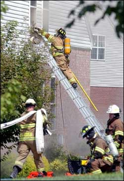 Franklin firefighters respond to a structure fire at 212 Tyne Drive in Founder&rsquo;s Pointe of Franklin yesterday. Heavy smoke poured out of the front door and windows as firefighters worked to control the fire.
