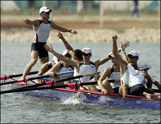 Olympic champion bowman Jason Read of the USA stands on the boat as he celebrates with teammates after the men's rowing eights final at the Athens 2004 Olympic Games Aug. 22, 2004. The U.S. won gold.