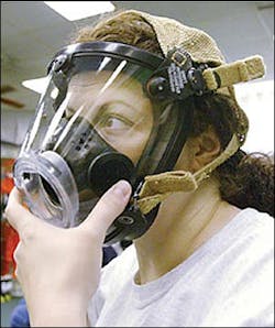Marie Farrell, with the New York Police Department, puts on her mask as part of her training at the Center for Domestic Preparedness. Marie Farrell, with the New York Police Department, puts on her mask as part of her training at the Center for Domestic Preparedness.