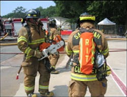 Assigned RIT personnel prepare to cut security bars to establish a secondary means of egress of interior crews. Assigned RIT personnel prepare to cut security bars to establish a secondary means of egress of interior crews.