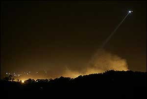 A helicopter hovers over the Lee Adjustment Center after inmates at the prison set three buildings on fire Tuesday, Sept. 14, 2004, in Beattyville, Ky.