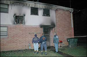 In the photo (from left to right): Captain Craig Haney and Senior Firefighter Henry McElvain with the Chattanooga Fire Investigation Division, and Sergeant Craig Johnson with the Chattanooga Police Department's Crime Scene Unit examine the second story window the father and two children reportedly used to escape the flames.