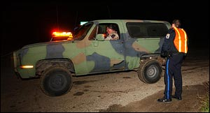Kirksville, Mo. Police Officer Scott Carriker, right, watches rescue crews leave the scene.