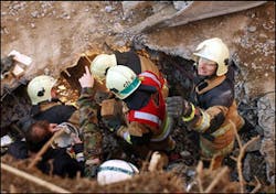 Members of rescue teams try to reach six fire-fighters, who are still trapped in the debris, after the ceiling of an underground car park collapsed during a fire, Saturday, Nov 27, 2004, in Gretzenbach, northern Switzerland