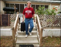 Richard DeMedicis, of Warrenville, leaves his home after packing a suitcase to evacuate. Police said he had to take his family out of the area by 6 p.m.