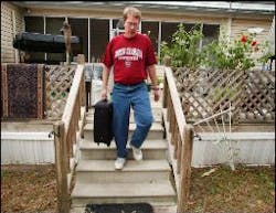 Richard DeMedicis, of Warrenville, leaves his home after packing a suitcase to evacuate. Police said he had to take his family out of the area by 6 p.m.