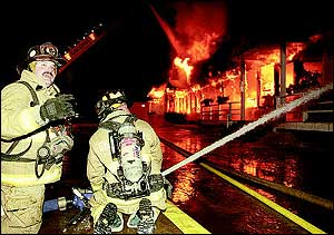 Firefighters from Gilford joined numerous other area fire departments in battling a six-alarm fire in Belmont Tuesday evening