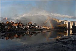 Firefighters shoot water into the burned part of a Kropf Lumberyard warehouse as a back hoe pulls out burning wood in Hesston, Kan., Wednesday afternoon, Jan. 26, 2005. The early morning blaze destroyed hundreds of thousands of dollars of building material inventory. Firefighters from Hesston, Newton and Moundridge, Kan., contained the fire but the large amount of wood in the metal structure continued to burn and smolder. Firefighters shoot water into the burned part of a Kropf Lumberyard warehouse as a back hoe pulls out burning wood in Hesston, Kan., Wednesday afternoon, Jan. 26, 2005. The early morning blaze destroyed hundreds of thousands of dollars of building material inventory. Firefighters from Hesston, Newton and Moundridge, Kan., contained the fire but the large amount of wood in the metal structure continued to burn and smolder.