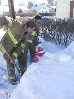 Rochester firefighter Don Penny, left, and fire Capt. Derek Peters work to shovel out a fire hydrant near 21 Walnut St. on Thursday morning. The hydrant is one of an estimated 1,200 in the city.