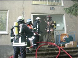 An instructor offers guidance to firefighters practicing thermal imaging skills. Safety, orientation and search skills were the primary emphasis of the drill.