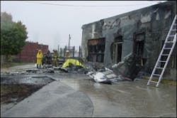 Upon impact, burning fuel was strewn across the parking lot as well as the front of the body shop. Upon impact, burning fuel was strewn across the parking lot as well as the front of the body shop.