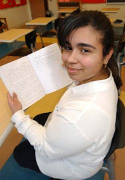 ODE TO HEROES: Cathy Ramos, a senior at The Child School on Roosevelt Island, holds up the poem she composed for the firefighters who gave their lives.