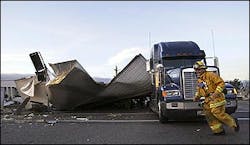 A firefighter dashes around the wreckage of a tractor-trailer hauling strawberries that was struck by an Amtrak Pacific Surfliner train, in Oxnard, Calif., Monday, Feb 14, 2005. The collision spilled several gallons of diesel fuel and caused injuries to several people in vehicles involved in the crash, authorities said. A firefighter dashes around the wreckage of a tractor-trailer hauling strawberries that was struck by an Amtrak Pacific Surfliner train, in Oxnard, Calif., Monday, Feb 14, 2005. The collision spilled several gallons of diesel fuel and caused injuries to several people in vehicles involved in the crash, authorities said.