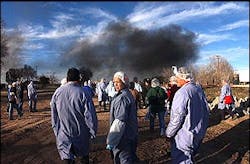 Boca Burger employees wait in an evacuation area near their plant as members of the Hobbs Fire Department battle a blaze at the plant, Monday, Feb. 14, 2005, in Hobbs, N.M.