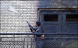 An Iranian worker, washes the wall of Arg mosque, where a fire broke out on Monday. An Iranian worker, washes the wall of Arg mosque, where a fire broke out on Monday.