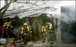 Firefighters tend to the smoldering remains of Judge Roy Bean's, a longtime Eastern Shore landmark pub, Tuesday, Feb. 15, 2005, in Daphne, Ala. The establishment on Scenic Highway 98 had operated since 1946, with singers Jimmy Buffett, Jerry Jeff Walker and Emmy Lou Harris among those performing at the old wooden building with a big fenced-in back yard.