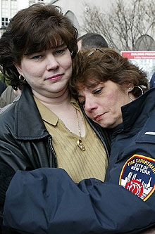 Eugene Stolowski was transferred from Cornell Medical Center yesterday as wife Brigid (near right) gets a hug from Jeanette Meyran, widow of firefighter Curtis Meyran.