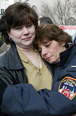 Eugene Stolowski was transferred from Cornell Medical Center yesterday as wife Brigid (near right) gets a hug from Jeanette Meyran, widow of firefighter Curtis Meyran. Eugene Stolowski was transferred from Cornell Medical Center yesterday as wife Brigid (near right) gets a hug from Jeanette Meyran, widow of firefighter Curtis Meyran.