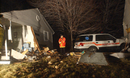 Brighton Township firefighter Dale Carter surveys the scene at 90 Walnut St. on Monday.