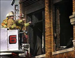 Anderson Township firefighters and an Indiana state fire marshall investigator look over the scene of fatal fire that killed three children and seriouly injured five others, Wednesday, Feb. 23, 2005, in Milroy Ind.