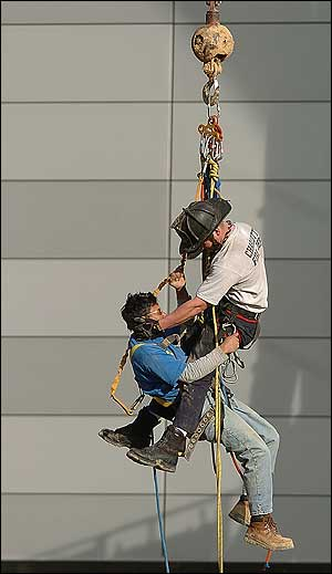 Charlotte firefighter Billy Mitchell, from rescue 10, does a high angle pick-off of an unidentified construction worker that was injured, after the portable lift that he was working on fell into the third floor windows of the new Uptown arena under construction, Wednesday afternoon, Feb. 23, 2005, in Uptown Charlotte, N.C. Over 20 fire fighters worked to rescue the worker, who was taken to Carolinas Medical Center for treatment of minor injuries. The rescue took firefighters about an hour as they worked to secure the lift at the arena.