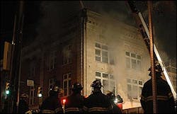 Knoxville Fire Department firefighters gather outside the Crimson building as smoke billows from the building in Knoxville, Tenn., Sunday, Feb. 27, 2005. Knoxville Fire Department firefighters gather outside the Crimson building as smoke billows from the building in Knoxville, Tenn., Sunday, Feb. 27, 2005.