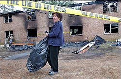 Mai Cuc Do retrieves some of her belongings from her apartment, which was destroyed by fire early Thursday morning, March 3, 2005, in Clarkston, Ga. The fire at the two-story apartment building killed three people, all of whom are believed to be family members. At least two others were injured in the blaze Wednesday night at Cherokee Woods Apartments. Mai Cuc Do retrieves some of her belongings from her apartment, which was destroyed by fire early Thursday morning, March 3, 2005, in Clarkston, Ga. The fire at the two-story apartment building killed three people, all of whom are believed to be family members. At least two others were injured in the blaze Wednesday night at Cherokee Woods Apartments.