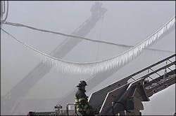 Icicles hang from utility wires as firefighters direct water hoses from aerial ladders in North Bergen, N.J. Icicles hang from utility wires as firefighters direct water hoses from aerial ladders in North Bergen, N.J.