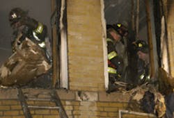 HEROES IN ACTION: Firefighters yesterday put out remnants of the fire, in which neighbors pitched in to pull the children to safety. HEROES IN ACTION: Firefighters yesterday put out remnants of the fire, in which neighbors pitched in to pull the children to safety.