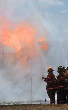 Firefighters get experience in the right way to extinguish a fire involving propane gas.
