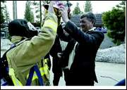 Brian D. Schultz A fire chief from Turkmenistan, Ashyr Ahunov, right, assists firefighter/paramedic Mike Schwartz with his equipment Thursday afternoon during an educational exchange program between North Lake Tahoe Fire Protection District and Turkmenistan firefighters.
