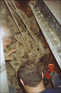 Members of the Port Colborne and Buffalo fire departments determine the best way to remove the victim from the compartment of the ship. He was wedged between the compartment wall and the pile of chain that fell on him. Members of the Port Colborne and Buffalo fire departments determine the best way to remove the victim from the compartment of the ship. He was wedged between the compartment wall and the pile of chain that fell on him.