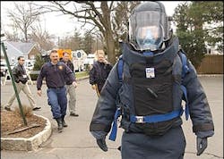 A member of the Union County, N.J., bomb squad in full protective gear walks through a parking lot at Kean University in Hillside, N.J., during a mock disaster drill. A member of the Union County, N.J., bomb squad in full protective gear walks through a parking lot at Kean University in Hillside, N.J., during a mock disaster drill.