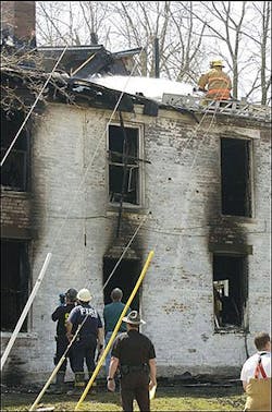 A firefighter sprays water on the roof of a house where a fire killed three people and injured two others near the campus of Miami University, Sunday, April 10, 2005, in Oxford, Ohio. (AP Photo/David Kohl) A firefighter sprays water on the roof of a house where a fire killed three people and injured two others near the campus of Miami University, Sunday, April 10, 2005, in Oxford, Ohio. (AP Photo/David Kohl)
