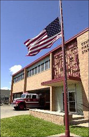 Honoring a Brother: An Amarillo Fire Department truck responds to a morning call as the American flag flies at half-staff at the department's Central Fire Station on Monday in honor of Christopher Brian Hunton.