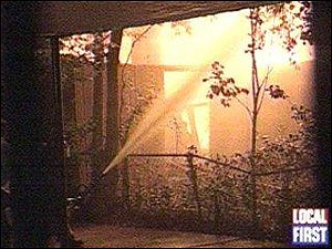 Firefighters tap the flames two hours later.