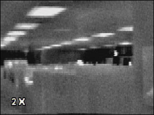 Photos 2A and 2B: A thermal image of a hallway in standard mode with 2X digital zoom activated. While details are brought closer, the image becomes pixilated in the process.