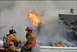 Arlington firefighters pause to regroup as a fire rages at The Church at Rush Creek Monday, May 2, 2005, in Arlington, Texas.(AP Photo/Fort Worth Star-Telegram, Brian Lawdermilk)