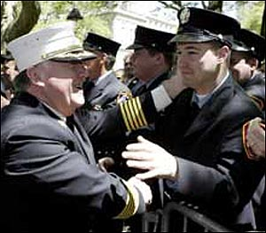 MAKING THEM PROUD: FDNY Chief Peter Hayden (left) greets firefighters after testifying to the council yesterday.