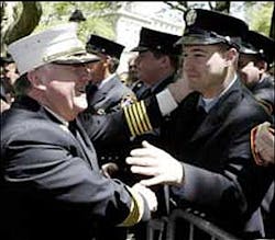 MAKING THEM PROUD: FDNY Chief Peter Hayden (left) greets firefighters after testifying to the council yesterday.
