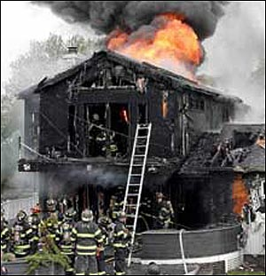 INFERNO: The East Rockaway home is engulfed in smoke and flames yesterday. The fire erupted in the kitchen just after the occupants had gone out &mdash; but a dog belonging to guests was tragically left behind.