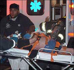 Longtime Four Seasons waiter Jorge Marquez is wheeled out of his East 59th Street building yesterday. He died in a fire on the 13th floor.