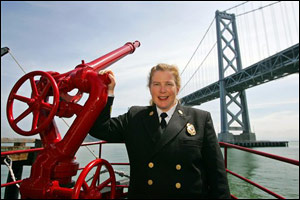 San Francisco Fire Chief Joanne Hayes-White poses aboard the fireboat Phoenix with the Bay Bridge in the background in San Francisco, Friday May 13, 2005. In her department, 230 of 1,700 firefighters are women.