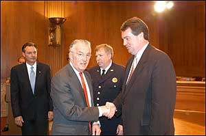 Senator Paul Sarbanes shakes hands with County Executive Douglas Duncan. U.S. Fire Administrator David Paulison (background, left) and Chief Thomas Carr look on.