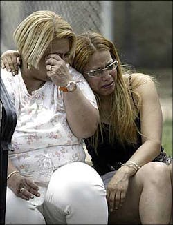 Two unidentified women react after arriving on the scene of a rowhouse fire in the Kensington section of Philadelphia, Sunday, June 12, 2005. Two unidentified women react after arriving on the scene of a rowhouse fire in the Kensington section of Philadelphia, Sunday, June 12, 2005.