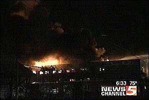 Firefighters remain at the scene of an overnight fire, dumping water to insure that it doesn't rekindle.