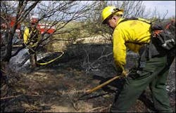 Capt. Joe Kelley, left, and firefighter John Feddema, from the Central Yavapai FIre District, work to cool down a hot spot near the northern edge of the Sunset Fire near the parking area at Badger Springs near Cordes Junction, Ariz., Tuesday, June 21, 2005. Capt. Joe Kelley, left, and firefighter John Feddema, from the Central Yavapai FIre District, work to cool down a hot spot near the northern edge of the Sunset Fire near the parking area at Badger Springs near Cordes Junction, Ariz., Tuesday, June 21, 2005.