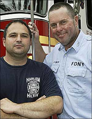 BLAZE OF GLORY: Lt. Kevin Flanagan (right) has a smile on his face after saving a 10-year-old boy from his burning Harlem apartment yesterday with an assist from firefighter Vic Leeber.